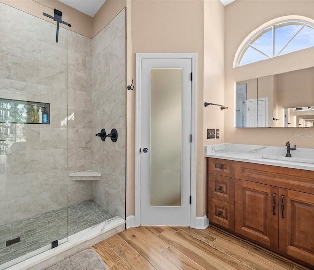 bathroom featuring a tile shower and vanity