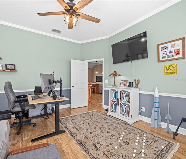 office space with wood-type flooring, ceiling fan, and ornamental molding