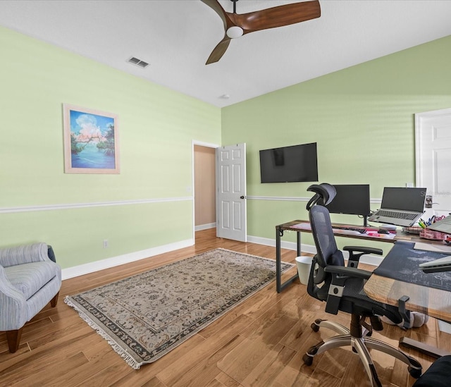 office with ceiling fan and light hardwood / wood-style flooring