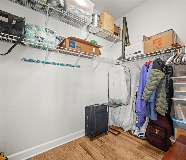 spacious closet featuring hardwood / wood-style flooring