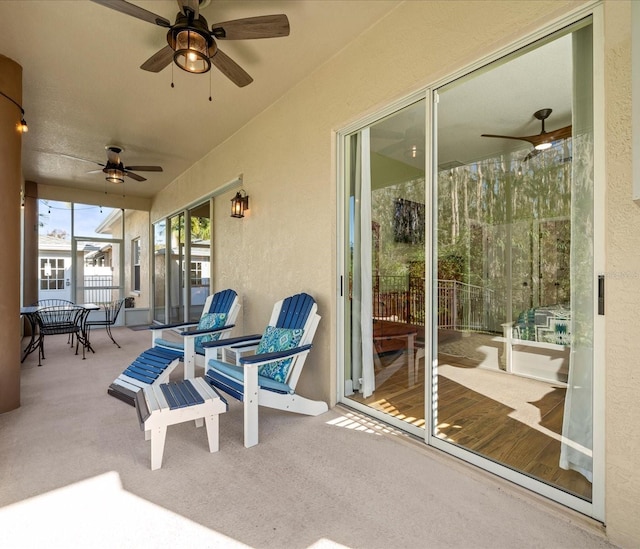 sunroom / solarium featuring ceiling fan