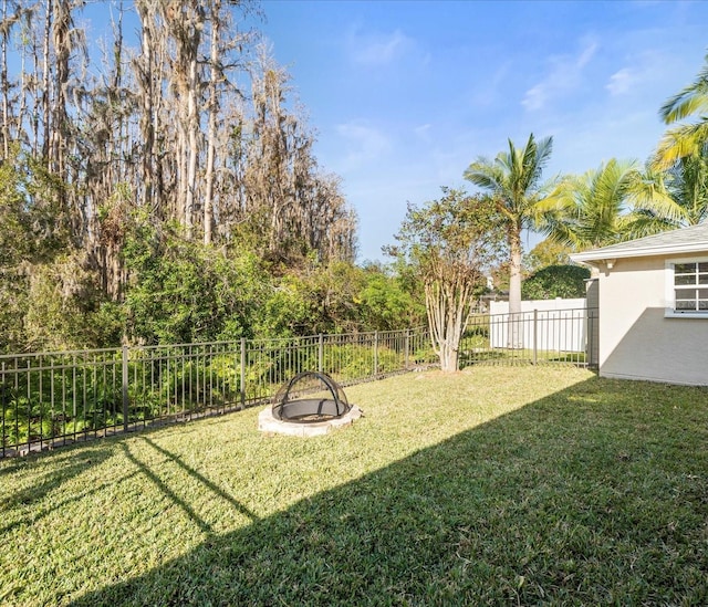 view of yard with a fire pit