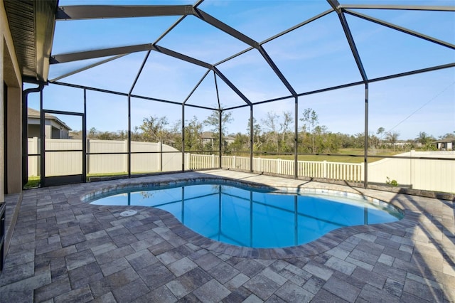 view of swimming pool featuring a patio area and glass enclosure