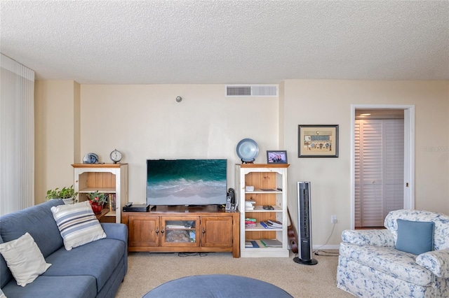 carpeted living room with a textured ceiling