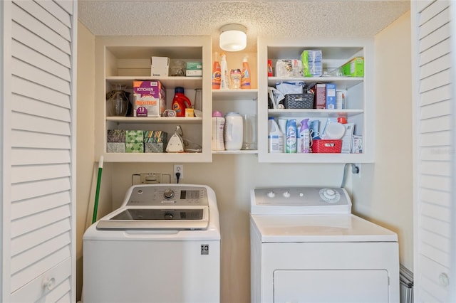 laundry room with washer and dryer and a textured ceiling