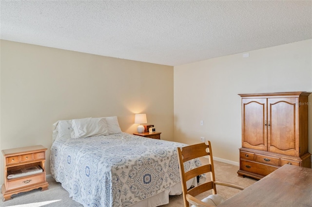 bedroom featuring a textured ceiling and light colored carpet