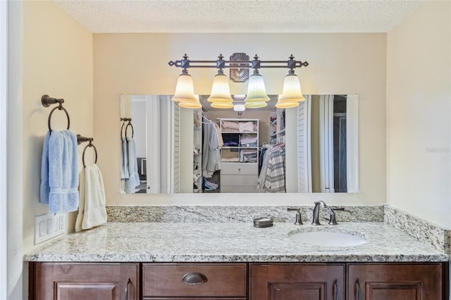 bathroom with a textured ceiling and vanity