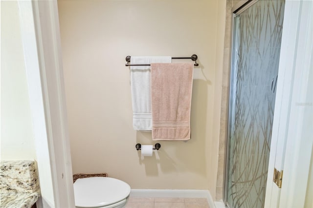 bathroom featuring toilet, tile patterned flooring, and walk in shower