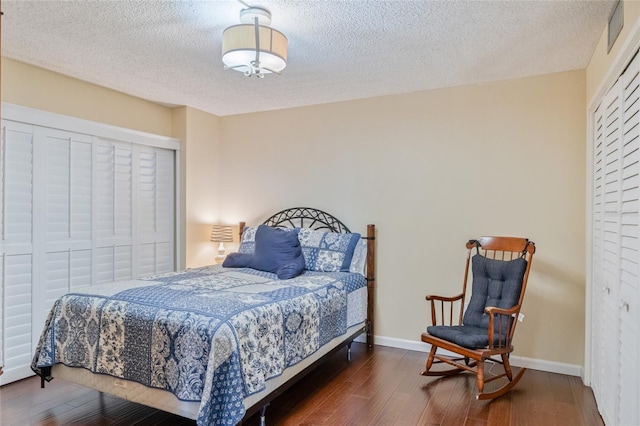 bedroom featuring a textured ceiling, a closet, and dark hardwood / wood-style flooring