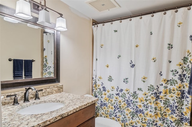 bathroom featuring toilet and vanity