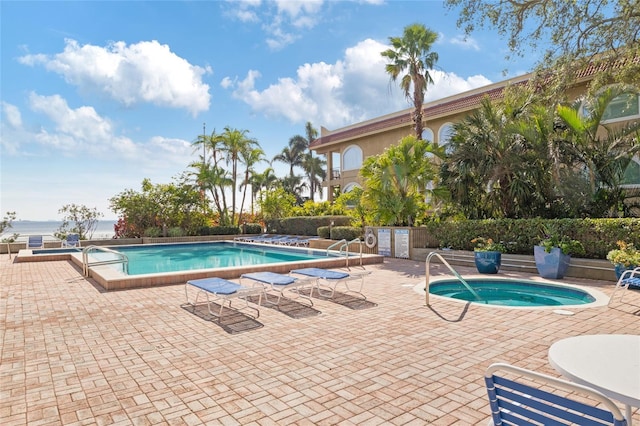 view of pool featuring a community hot tub and a patio