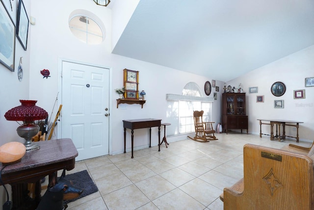 foyer with lofted ceiling and light tile patterned floors