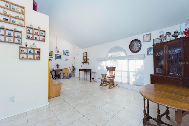 living area featuring lofted ceiling and light tile patterned floors