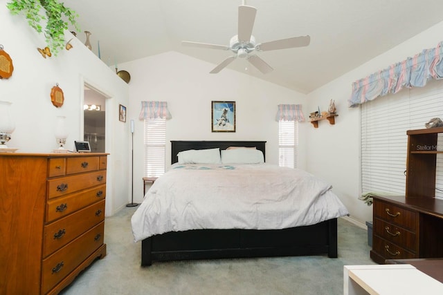 bedroom featuring lofted ceiling, light colored carpet, and ceiling fan