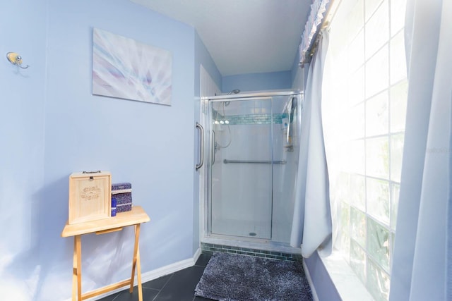 bathroom with tile patterned flooring and walk in shower