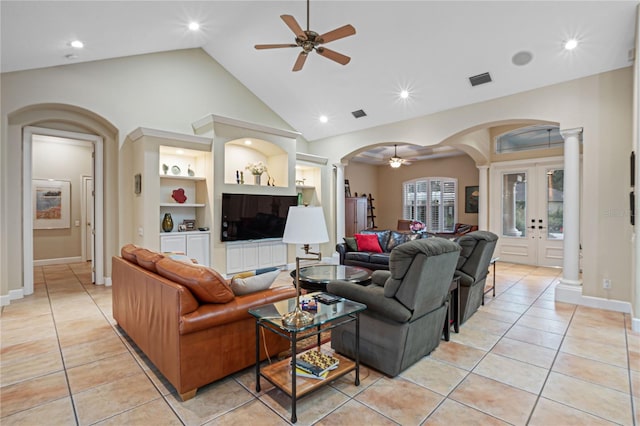 living room featuring decorative columns, arched walkways, built in features, ceiling fan, and french doors