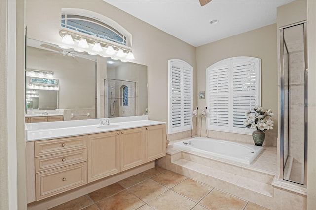 bathroom with ceiling fan, a stall shower, a bath, tile patterned floors, and vanity