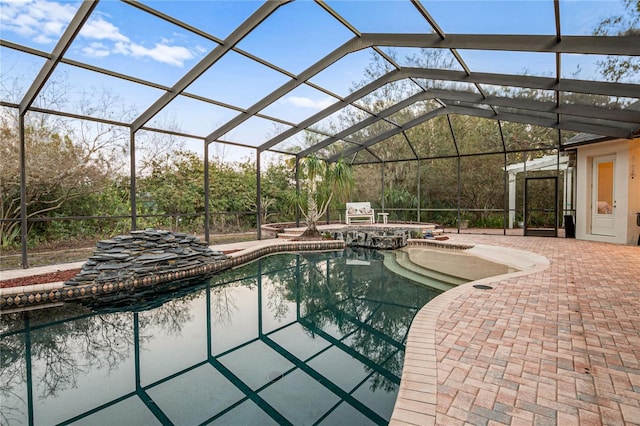 outdoor pool featuring a patio, a lanai, and a hot tub