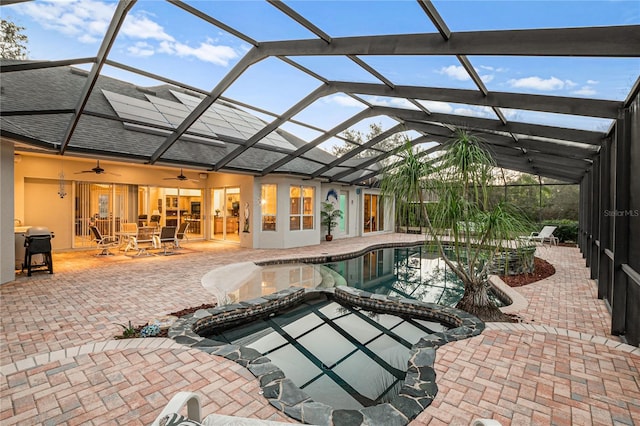 view of swimming pool featuring a lanai, a patio, and ceiling fan