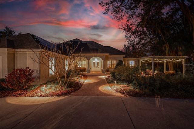 view of front of property featuring stucco siding and a pergola