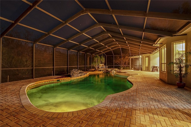 pool with glass enclosure and a patio