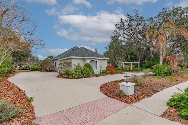 view of front of property with stucco siding and decorative driveway