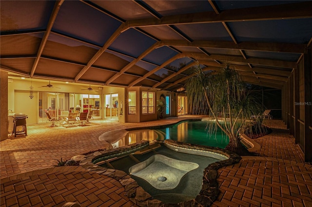 outdoor pool featuring glass enclosure, an in ground hot tub, a patio area, and ceiling fan