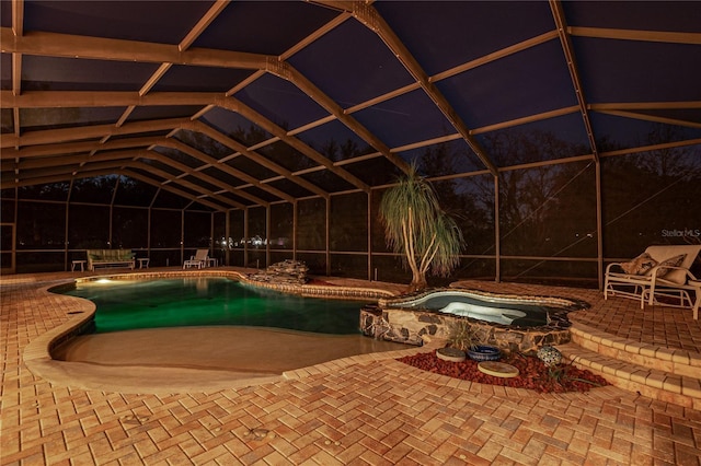 view of pool with a pool with connected hot tub, a lanai, and a patio area