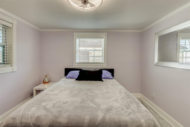 bedroom with crown molding and a textured ceiling