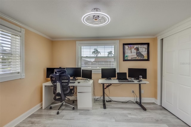 office space with light wood-type flooring and ornamental molding