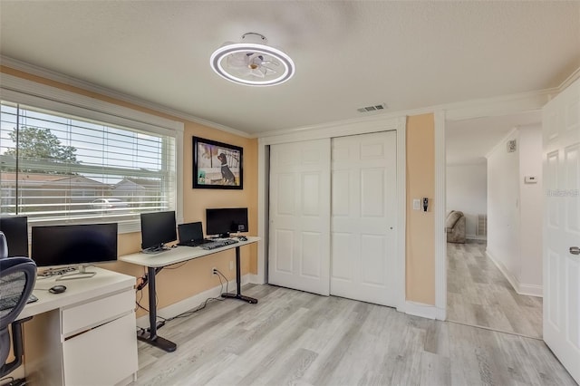 office with light hardwood / wood-style flooring and ornamental molding