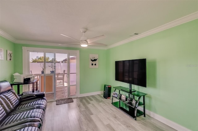 living room featuring ceiling fan, light wood-type flooring, and ornamental molding