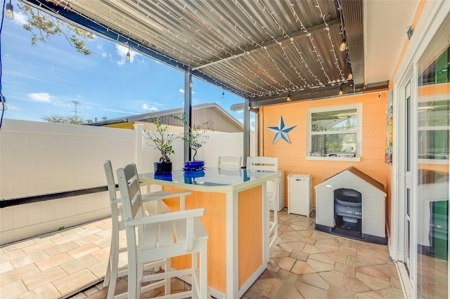 view of patio featuring washing machine and dryer and an outdoor bar