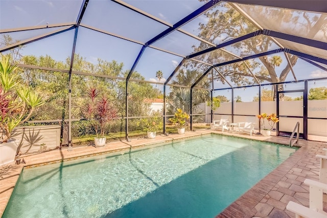 view of swimming pool featuring a lanai and a patio