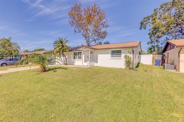 back of property featuring a yard and central AC