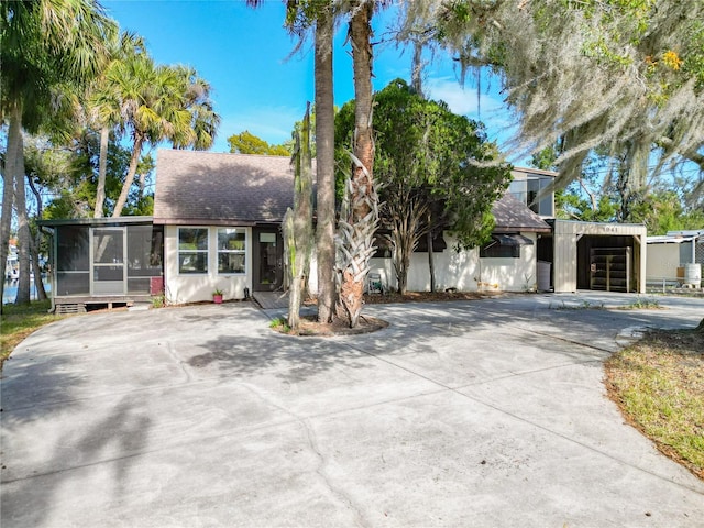 view of front of house with a sunroom and a garage