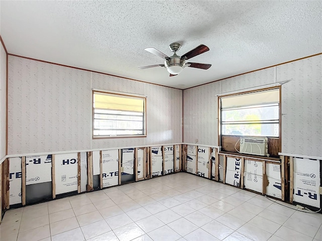 spare room with ceiling fan, crown molding, cooling unit, and a textured ceiling