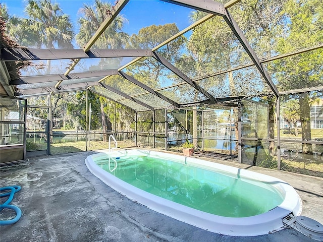 view of pool with glass enclosure