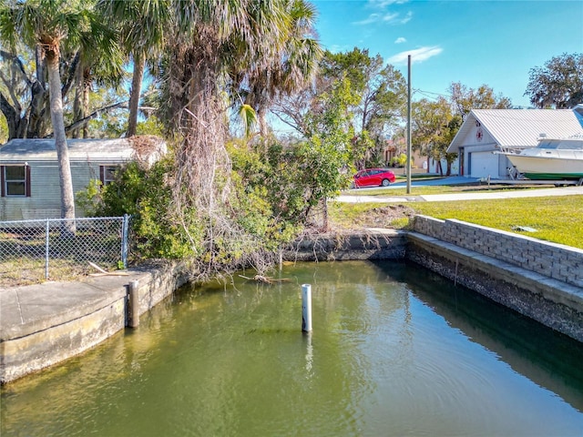 view of dock featuring a lawn and a water view