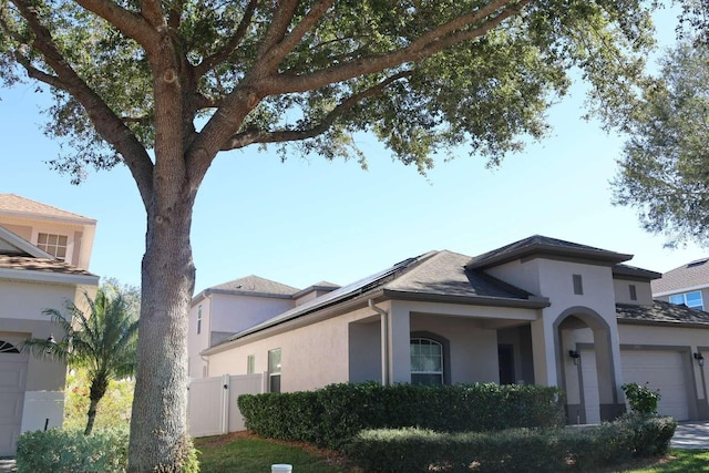 view of front of home with solar panels and a garage