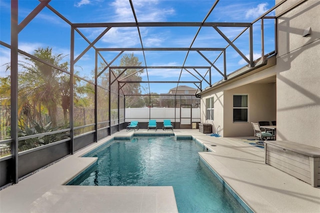 view of swimming pool featuring glass enclosure and a patio area