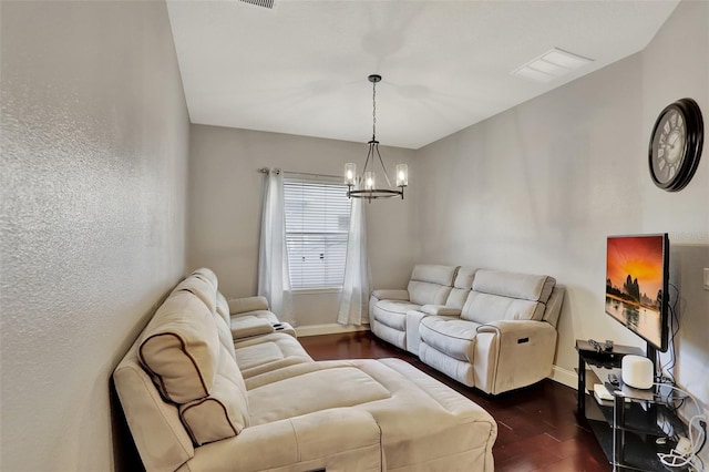 living room with an inviting chandelier and dark hardwood / wood-style floors