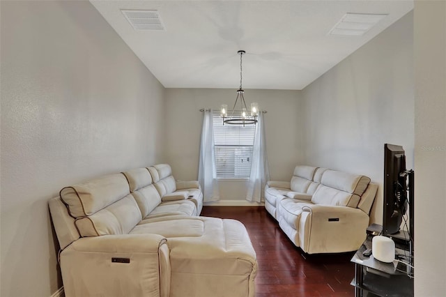 living room featuring dark wood-type flooring and a notable chandelier