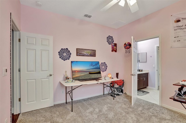 carpeted office featuring ceiling fan