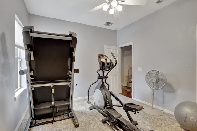 exercise area featuring light carpet, ceiling fan, and plenty of natural light