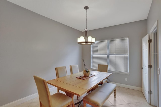 tiled dining area with a chandelier