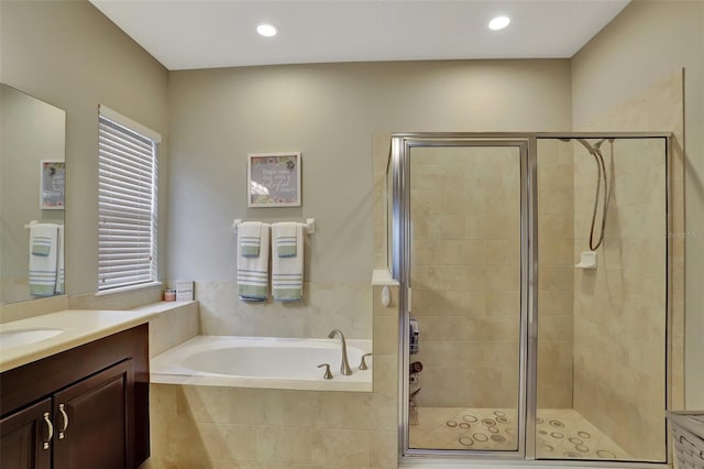 bathroom with vanity and separate shower and tub