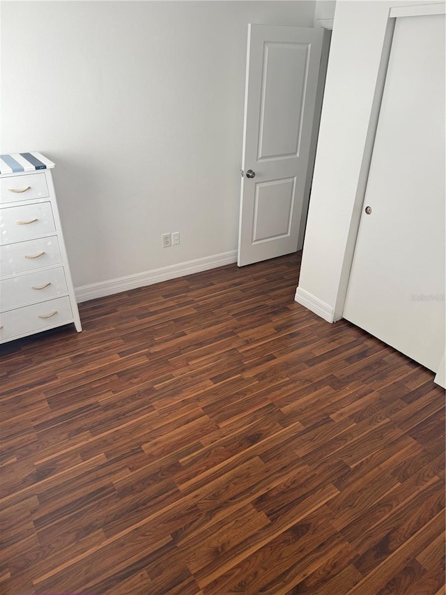 unfurnished bedroom with dark hardwood / wood-style floors