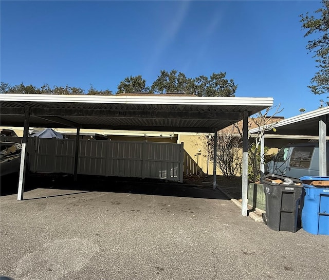 view of parking / parking lot featuring a carport