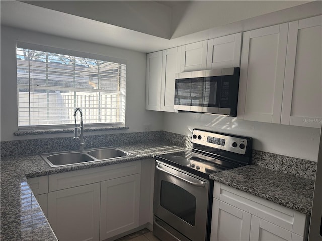 kitchen with white cabinetry, sink, and stainless steel appliances